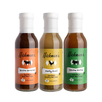 Three bottles of Hickman's marinated meats on a white background